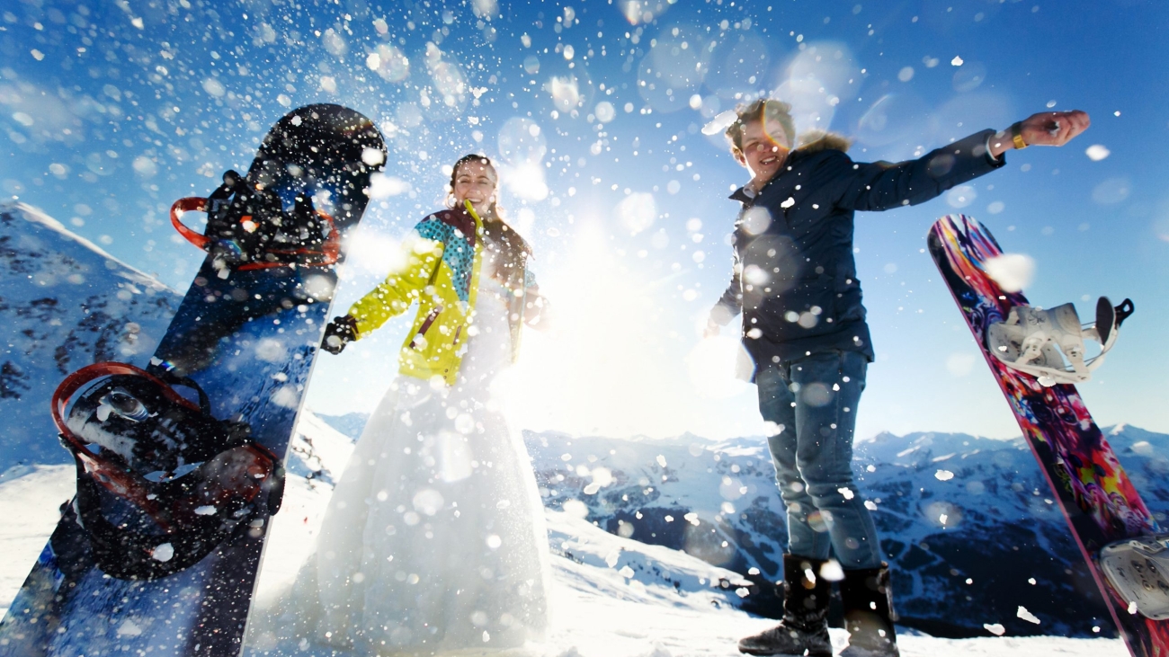 bride and groom in love throw snow background of the Alps Courchevel